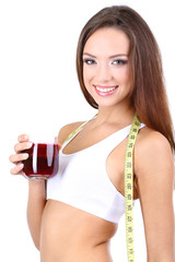 Beautiful girl with fresh juice and measuring tape isolated