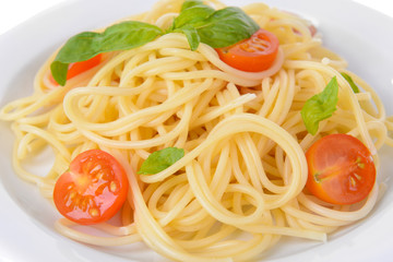 Delicious spaghetti with tomatoes on plate close-up