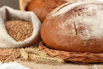Rye bread with grains on sackcloth on table close up