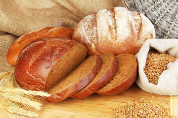 Rye bread with grains on table on sackcloth background