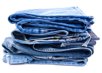 Pack of worn blue jeans isolated on white background