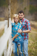 Portrait of young couple dressed in shirt, outdoors in the park
