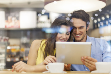Couple in cafe with digital tablet