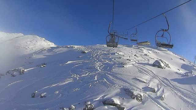 Ski lift chairs on hillside, Zillertal, Austria, time lapse