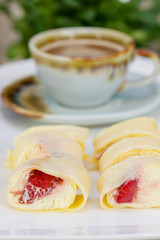 Crepe Cake strawberries and cup of coffee