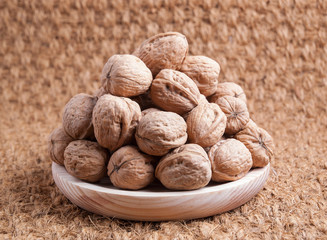 Walnuts on a wooden plate