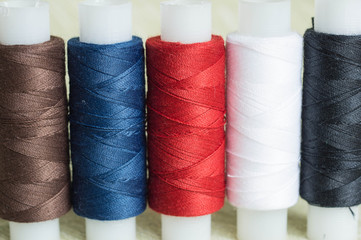 Some coils of threads on a textile background close up