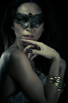Lady.Beautiful young woman in mysterious black Venetian mask. Fa