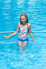 Girl in summer outdoor pool.