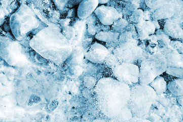 Ice background. Frozen white stones under thick ice texture