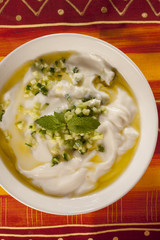 Tzatziki in a bowl, served with mint.