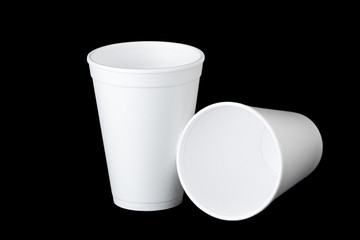 two styrofoam cups on black