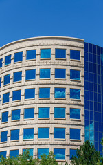 Curved Office with Clouds Reflected in Blue Glass