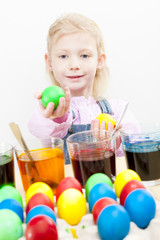 portrait of little girl during Easter eggs'' coloration