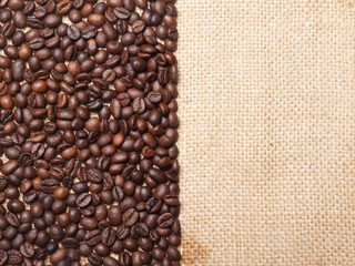 Coffee beans on burlap background