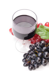 Glass of black wine and grapes on white background