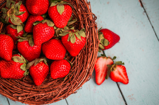 Strawberries in the basket on wooden background