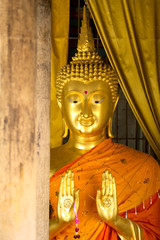 gold buddha statue and wood  pole