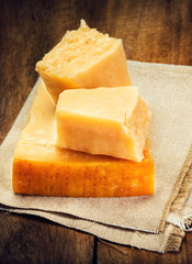 Parmesan Cheese on Wooden Background close up. Piece of Parmesan