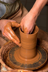 hands of a potter, creating an earthen jar
