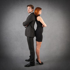 Angry full body couple studio portrait against grunge background