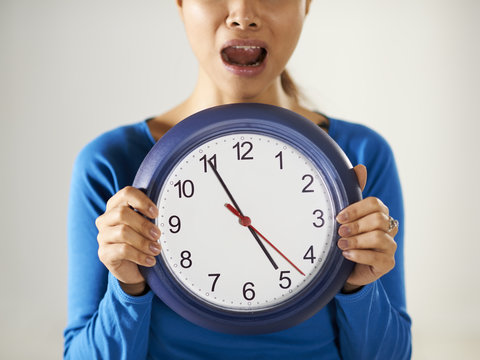 Asian Girl Holding Big Blue Clock With Stress