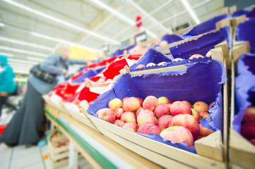 Bunch of apples in wood boxes in supermarket