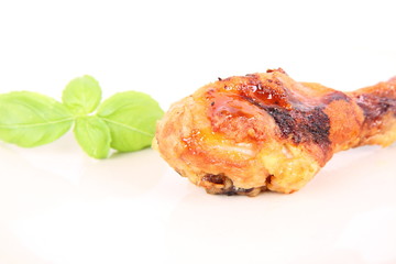 Fried chicken leg decorated with basil