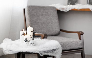 Grey upholstered chair in Halloween setting