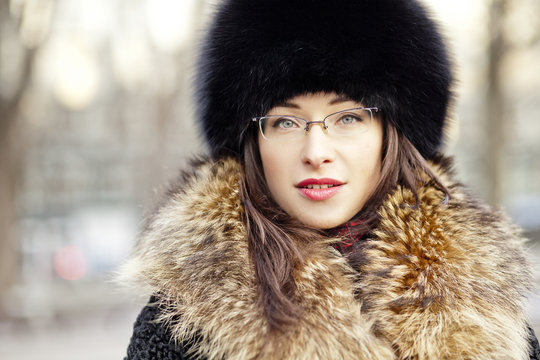 Woman wearing fur hat and glasses
