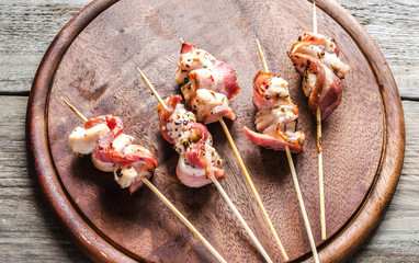Grilled bacon skewers with chicken meat