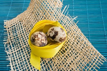 Easter background with quail eggs and ribbons