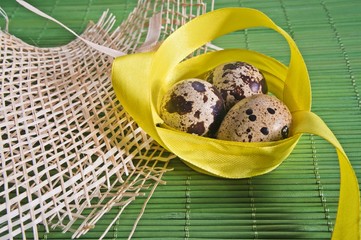 Easter background with quail eggs and ribbons