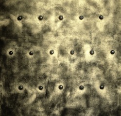 Grunge gray metal plate with rivets screws background texture