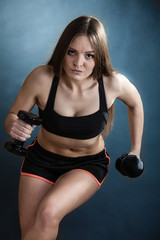 Fototapeta na wymiar Fitness girl training shoulder muscles lifting dumbbells