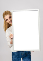 Young blonde student girl smiling holding a white blank board. - 61651641