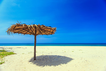 Sun umbrella on the white beach