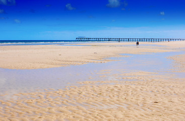 Beautiful wide open sandy beach over looking jetty