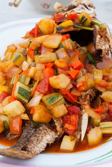 Fried fish with sour and sweet sauce .