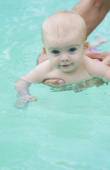 Fototapeta na wymiar Adorable baby enjoying her swim