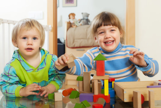 Emotional  children playing with wooden toys