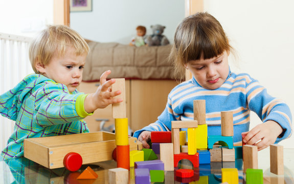 children  with wooden blocks