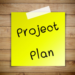 Project plan on sticky paper on Brown wood plank wall texture ba