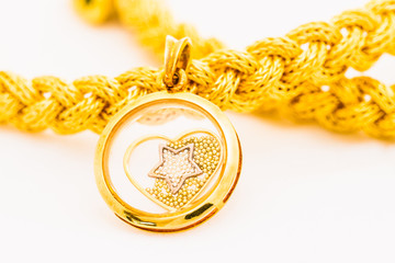 gold pendant and braid bracelet
