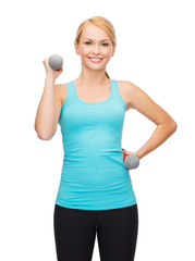 young sporty woman with light dumbbells