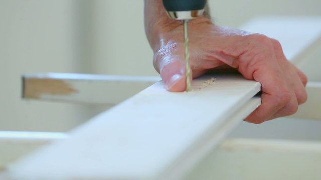 drilling holes in the wooden board electric drill