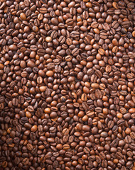 Numerous coffee beans which have been scattered all over the sur