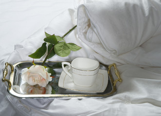 tray with cup and rose on silk