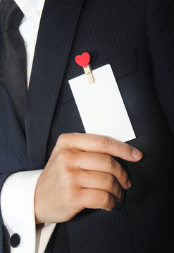 man holding a namecard with heart