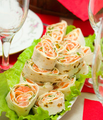 Salmon lavash rolls served with fresh salad leafs - 61664672